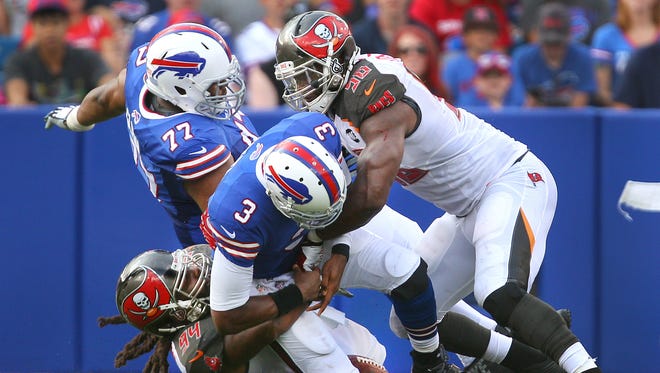 Bills quarterback EJ Manuel is sacked by Tampa Bay's Adrian Clayborn (94) and Michael Johnson (90).  His fumble on the play was returned for a Bucs touchdown in a 27-14 Buffalo loss.
