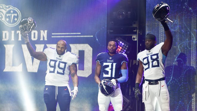 Tennessee Titans defensive tackle Jurrell Casey (99), safety Kevin Byard (31), and linebacker Brian Orakpo (98), show off their new uniforms during the Titans uniform reveal event held at Broadway and 1st Avenue in Nashville, Tenn., Wednesday, April 4, 2018.