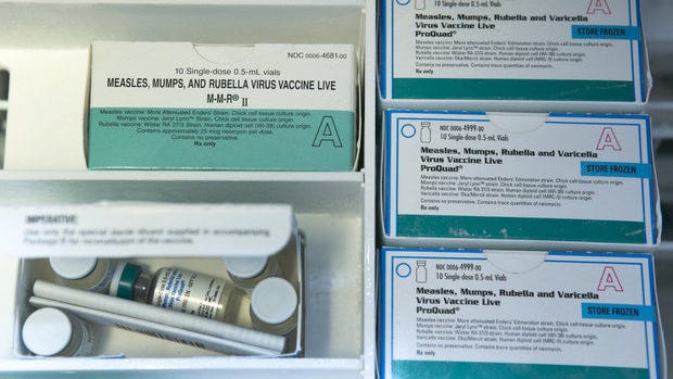 Boxes of single-dose vials of the measles-mumps-rubella virus vaccine live, or MMR vaccine and ProQuad vaccine are kept frozen inside a freezer at the practice of Dr. Charles Goodman in Northridge, California, on Thursday, Jan. 29, 2015.