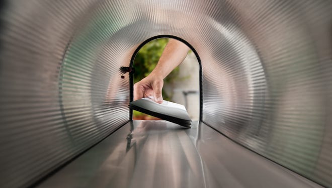 Close-up Of Person Hands Taking Letters View From Inside The Silver Mailbox