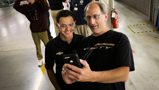 Lansing Grand River Assembly Plant worker James Wenzlick, right, takes a selfie with NASCAR driver Kyle Larson, Thursday, June 7, 2018, as Larson tours the plant.