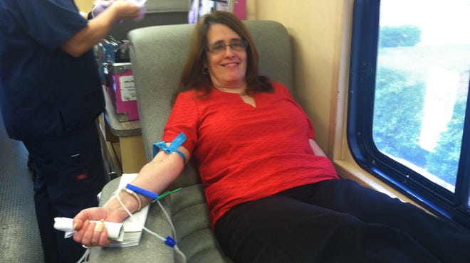 Rose Simpson, administrative assistant to the publisher at the Poughkeepsie Journal, gives blood on Monday.
