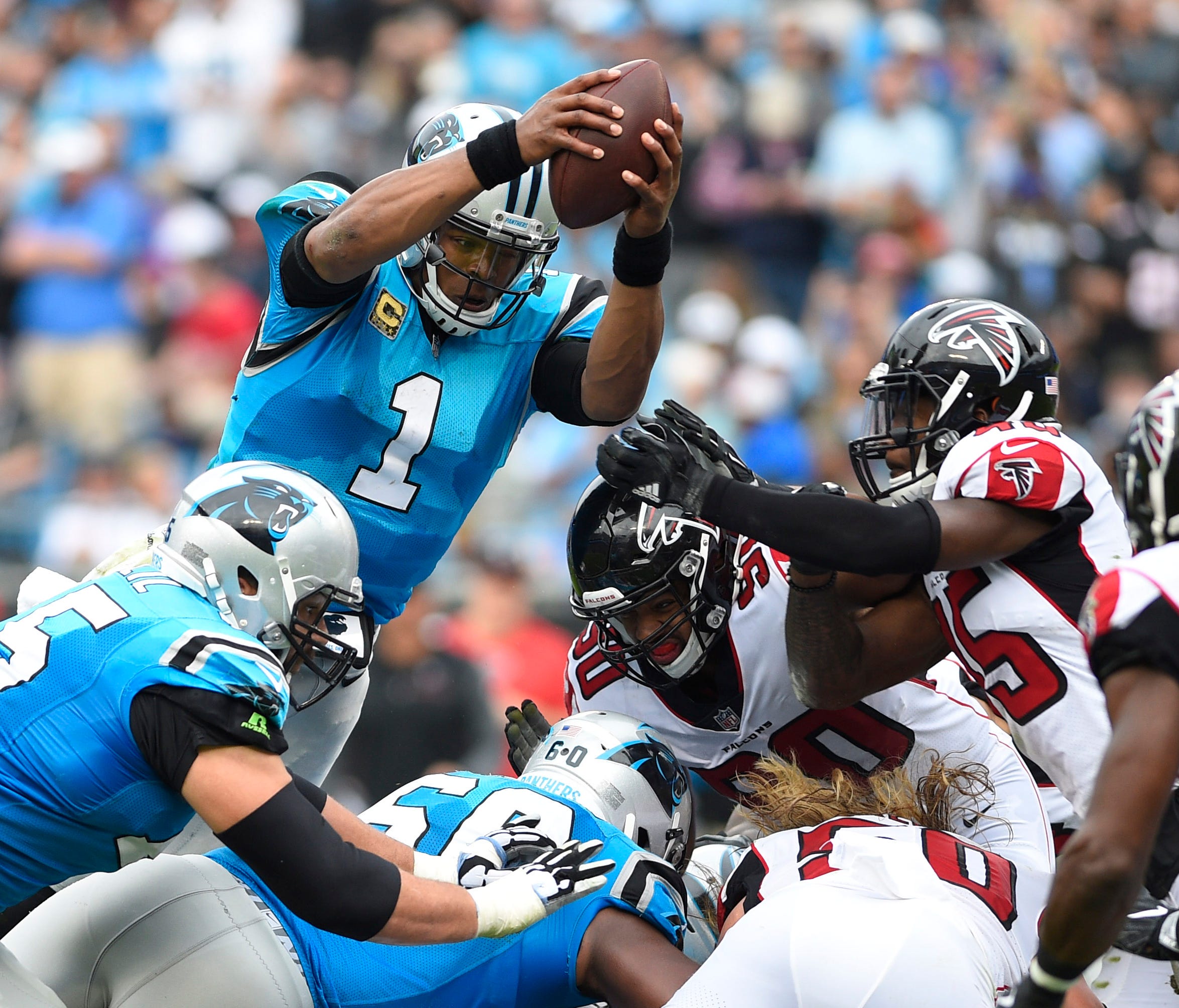 Carolina Panthers quarterback Cam Newton (1) reaches for a first down in the third quarter.