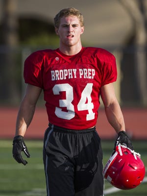 Brophy Prep's Noah Pittenger (34) heads onto the field during a practice at Brophy High School on July 28, 2016 in Phoenix, Ariz.