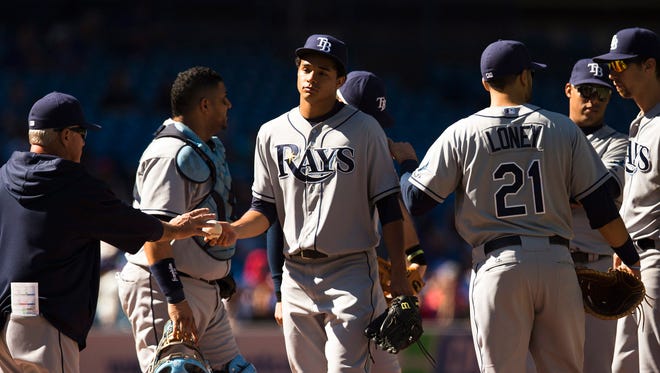 Tampa Bay's Chris Archer, center, is taken out of the game by manager Joe Maddon, left, during the third inning of the Rays' 7-2 loss in Toronto.