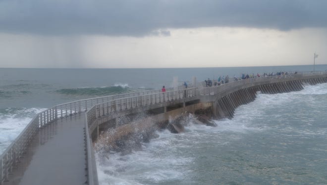 Offshore morning showers cloud up the skies at the Sebastian Inlet on Saturday, Dec. 17, 2016.