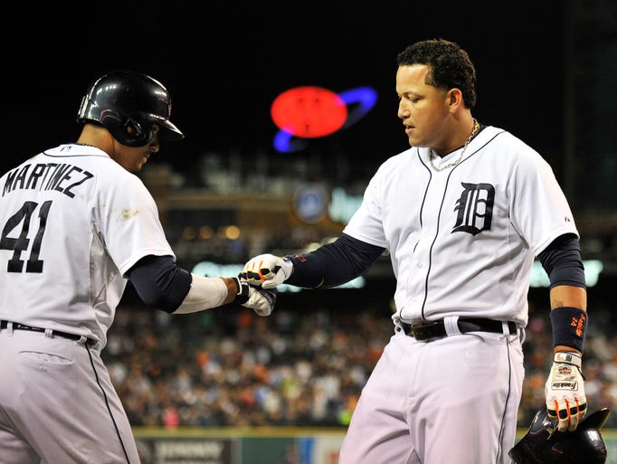 Tigers' Victor Martinez congratulates Miguel Cabrera, right, after Cabrera's solo home run in the fourth inning.