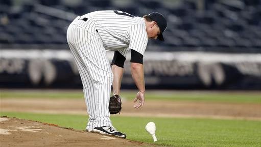 New York Yankees relief pitcher Kirby Yates tosses the rosin bag onto the mound after plunking three batters and allowing four runs in the Yankees 9-6 loss to the Texas Rangers in a baseball game that began on Monday, June 27, 2016 and ended Tuesday, June 28, 2016 in New York.