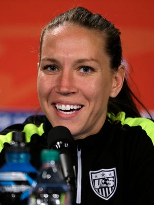 In this July 4, 2015 file photo, U.S. midfielder Lauren Holiday speaks during a news conference for the Women's World Cup soccer final in Vancouver, British Columbia, Canada. The New Orleans Pelicans say guard Jrue Holiday will be taking indefinite leave to care for his wife, Lauren Holiday, who is pregnant and needs brain surgery. "We are all praying for a healthy delivery of their first child and a successful surgery for Lauren," Pelicans general manager Dell Demps said in a prepared statement provided Sunday, Sept. 4, 2016 by the club.