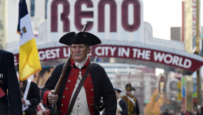 A parade participant  marches along the Veterans Day Parade route in downtown Reno on Nov. 11, 2014.