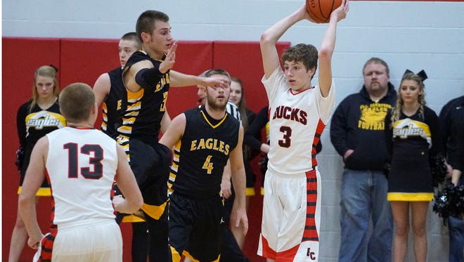 Buckeye Central's Max Loy looks to pass around the Colonel Crawford defense Friday evening.