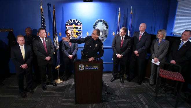 Louisville Metro Police Chief Steve Conrad, center, is flanked by law enforcement officials as he announced the recent formation of LMPD’s gang task force which has already yielded over 80 arrests.Jan. 23, 2017