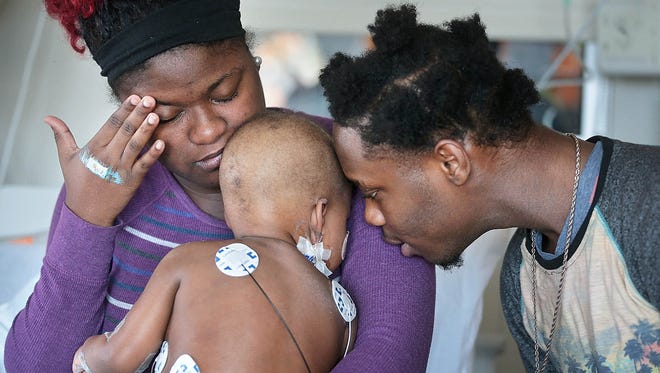 Quintrissa Everhart  holds her daughter, Lyric Everhart, a 20-month-old heart patient at Le Bonheur Children's Hospital, while Quintrell Everhart, the baby's uncle, tries to cheer her up. On Saturday the hospital's Heart Institute performed a heart transplant on Lyric, who suffered acute heart failure.