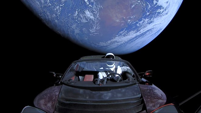 SpaceX's "Starman," a mannequin dressed in a spacesuit, drives Elon Musk's Tesla Roadster high above Earth following its launch atop the first Falcon Heavy rocket. The rocket lifted off from Kennedy Space Center on a demonstration flight at 3:45 p.m. Tuesday, Feb. 6.