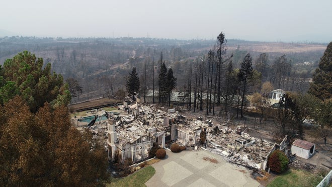 Homes in the River Ridge Park subdivision show the damage from the Carr Fire Wednesday August 1, 2018 in Redding, CA. This home at 3474 Showboat Ct. is completely destroyed.