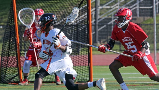 White Plains Miles Tilman (22) scores on North Rockland defense during boys lacrosse Section 1 Class A opening-round game at White Plains High School on May 16, 2016.  White Plains defeats North Rockland 13-12.