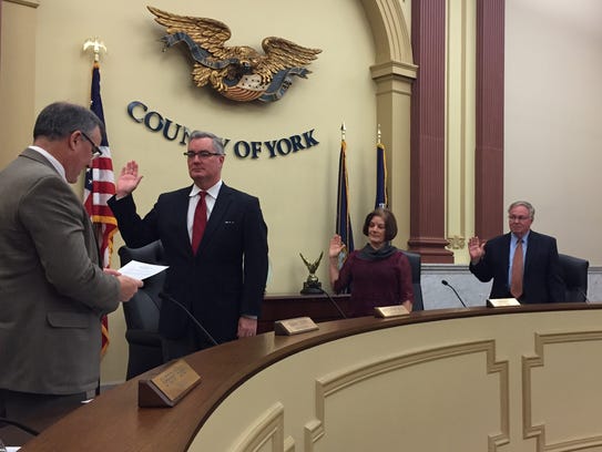 In this 2016 file photo, York County Administrator Mark Derr swears in the York County commissioners, from left: Chris Reilly, Susan Byrnes and Doug Hoke.