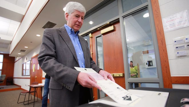 Michigan Gov. Rick Snyder votes during the special election for Proposal 1 at a voting center in Superior Township on Tuesday, May 5, 2015.