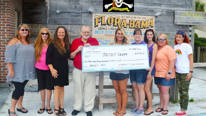 Perdido Key’s “Pirates of Lost Treasure” recently made and sold lunches at the Flora-Bama’s Mullet Toss and were able to raise and donate $5,730 to Secret Santa. Pictured left to right: Dana Peeterse, Ruby Burgess, Cinnamon Swift, Bill Stromquist, Jenifer Surface, Angela Houghton, Brittany Houghton, Cheryl Spencer, and Melissa Purvis.