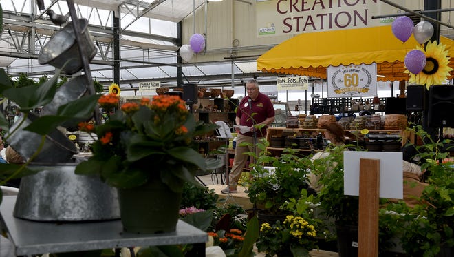Ned Wilson, owner of Wilson's Garden Center, recounts the history of the family business his father, Carl, started 60 years ago. The Newark business celebrated its anniversary on Tuesday, the first day of spring.