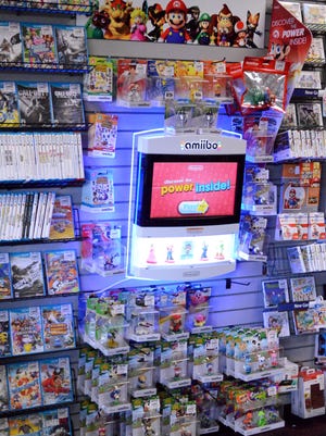 A display screen advertises Amiibo, an action figure type gaming icon that is used on the Wii U.