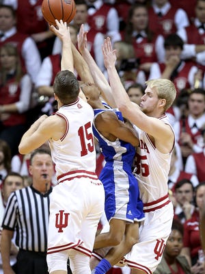 Eastern Illinois Panthers guard Cornell Johnston (2),middle, is sandwiched by Indiana Hoosiers  Tim Priller (35),right, and Harrison Niego (15) at Assembly Hall. 