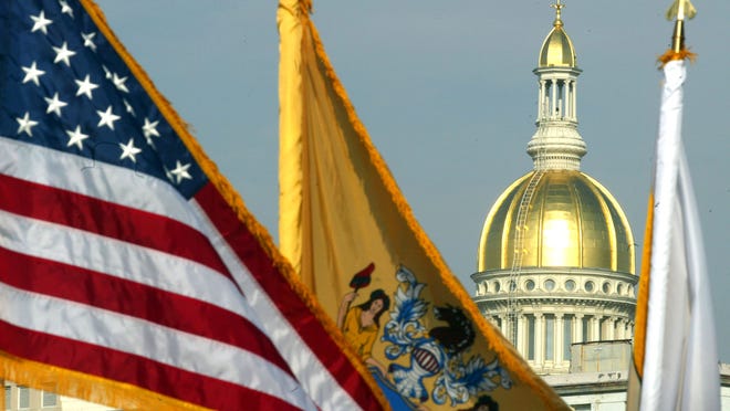 An Assembly panel has advanced the Aid in Dying for the Terminally Ill Act, which would allow patients to obtain and administer medication to end their lives. Asbury Park Press file The American and New Jersey flags fly outside the War Memorial in Trenton with the State House visible in the background. NEW JERSEY PRESS MEDIA FILE With the Statehouse dome in the background, flags fly outside the War Memorial in Trenton Tuesday where Governor Chris Christie took his oath of office. 1/19/10 - TRENTON - INAUGURATIONTC0119O - PAGE1 - ASBURY PARK PRESS PHOTO BY THOMAS P. COSTELLO