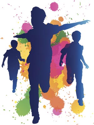 Young boys running against a paint splatter background