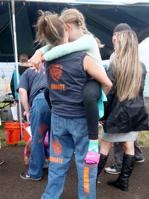 A female inmate shares a moment with her daughter during the annual Through a Child's Eyes event at the Coffee Creek Correctional Institute on July 10, 2016 in Wilsonville.