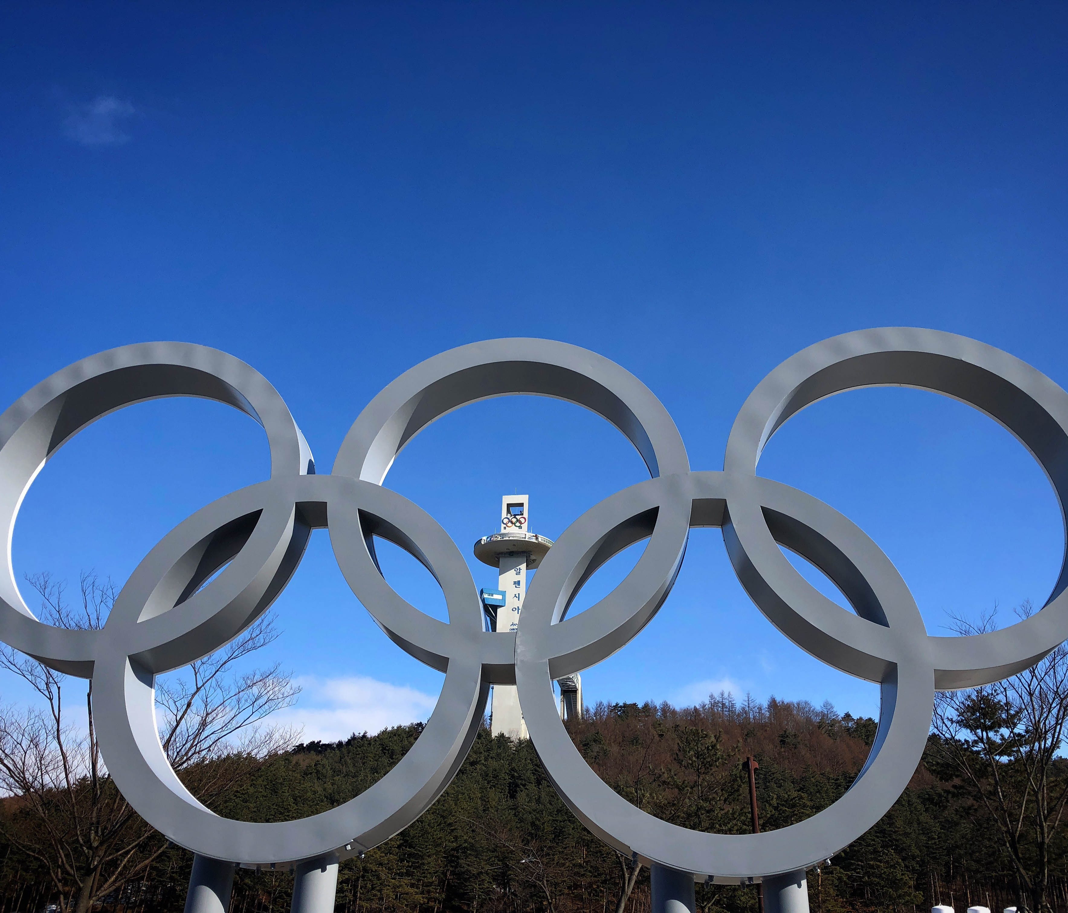 The Olympic rings and the Alpensia Ski Jumping Center are seen in the distance near the Main Press Center in advance of the PyeongChang 2018 Olympic Winter Games.