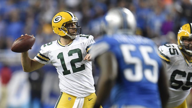 Green Bay Packers quarterback Aaron Rodgers (12) looks to make a pass against the Detroit Lions at Ford Field.