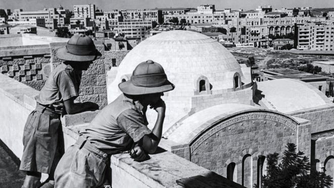 This photo taken in 1947 shows two British officers on the rooftop of the YMCA overlooking the modern city of Jerusalem.