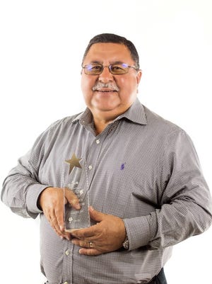 Oscar Casillas, the CEO/President of BEPC Inc., holds the Supplier of the Year  award presented by the Southwest Minority Supplier Development Council.