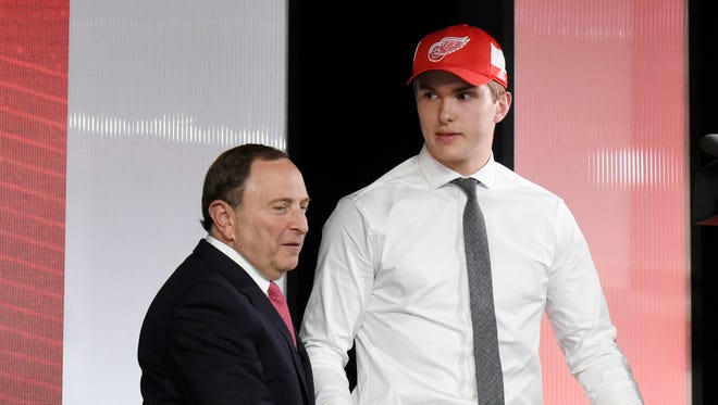 Michael Rasmussen greets NHL commissioner Gary Bettman after being selected as the No. 9 overall pick to the Detroit Red Wings in the first round of the 2017 NHL draft at the United Center.