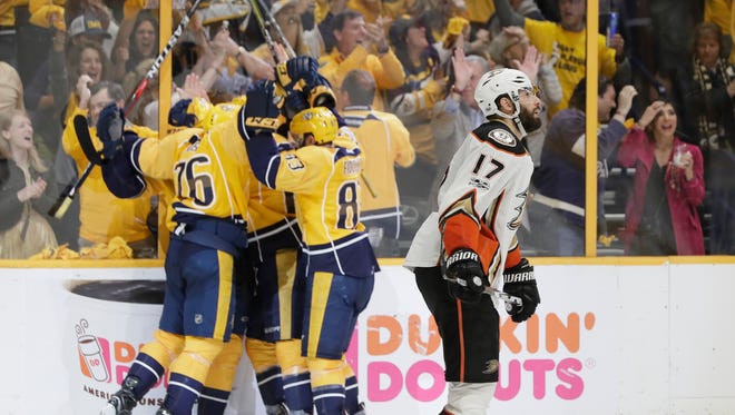 Ducks center Ryan Kesler skates past Nashville Predators players as they celebrate a goal by Filip Forsberg during the third period.
