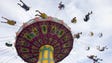 Guests takes a ride on the Wave Swinger during the