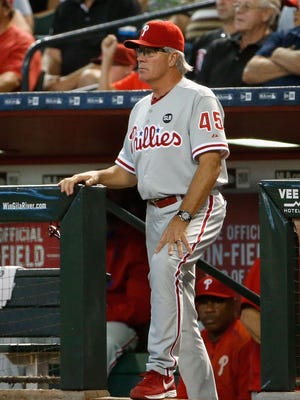 Phillies manager Pete Mackanin watches from the dugout. Mackinin had the interim title removed Tuesday and will manage the team next year, with an option for 2017.
