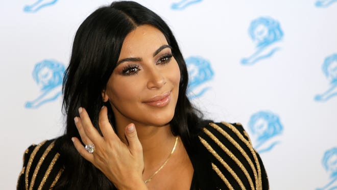 Television personality Kim Kardashian poses for photographers as she attends the Cannes Lions 2015 in Cannes, southern France on June 24, 2015.