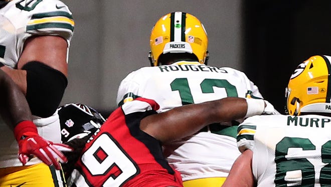 Packers quarterback Aaron Rodgers is sacked by Falcons defensive end Adrian Clayborn.