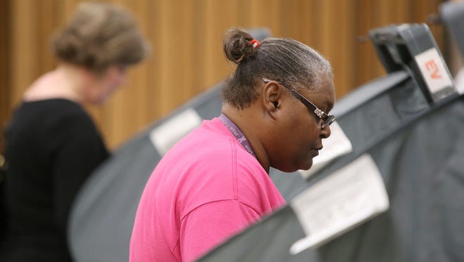 Teresa Boyd, right, participates in early voting at the Madison County Agriculture Complex Auditorium on Friday.