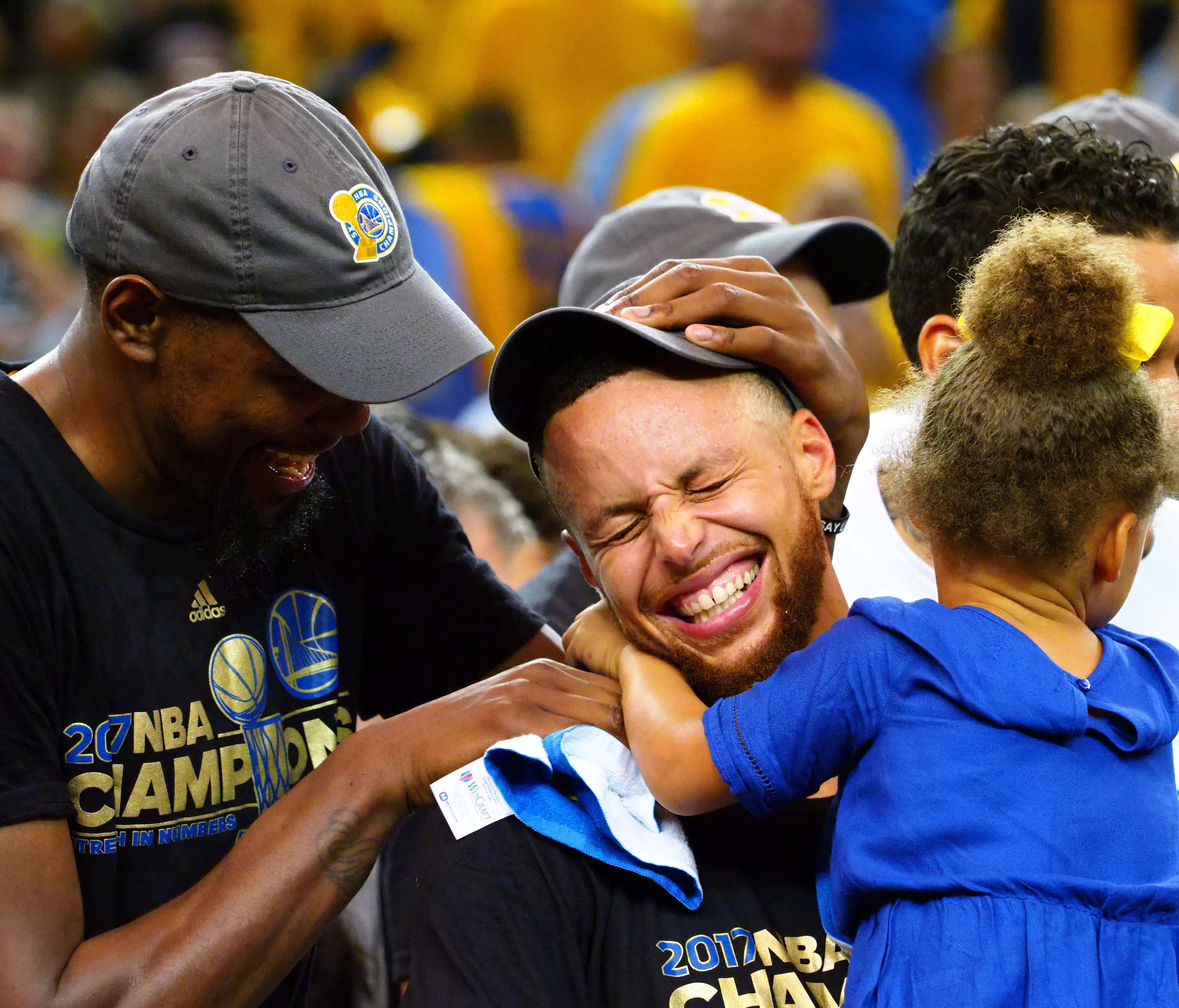 Golden State Warriors forward Kevin Durant (35), guard Stephen Curry (30) celebrate with his caught Riley in game five of the 2017 NBA Finals at Oracle Arena.