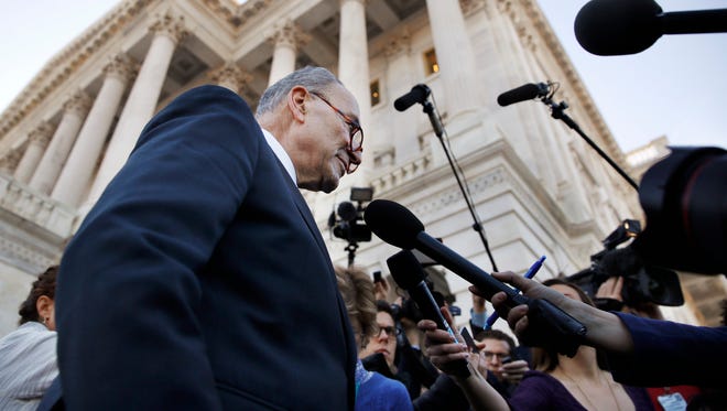 Senate Minority Leader Chuck Schumer, D-N.Y., center, speaks to the media outside the Capitol after meeting with President Donald Trump, Friday, Jan. 19, 2018, in Washington.