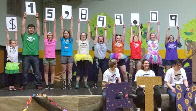 Students reveal the total raised for the Children's Miracle Network during last month's Elmira College Dance Marathon.
