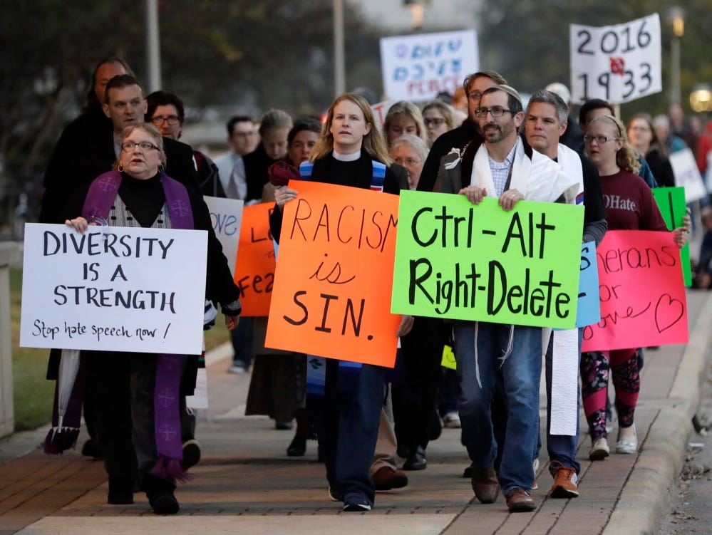 Demonstrators hold signs as they chant outside the venue where Richard Spencer, who leads a movement that mixes racism, white nationalism and populism, was scheduled to speak at Texas A&M University on Dec. 6, 2016, in College Station, Texas.