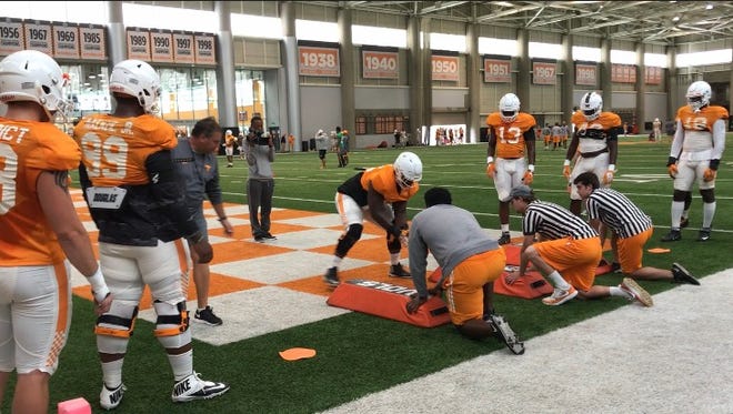 The Tennessee defensive linemen go through drills at spring practice on Tuesday.
