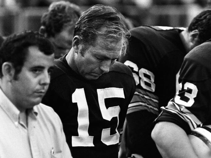 Green Bay Packers quarterback Bart Starr (15) bows his head during a moment of silence for former coach Vince Lombardi, who was dying of cancer, as the Packers hosted the New York Giants in a preseason game on Aug. 8, 1970. Lombardi died 3½ weeks later in Washington, D.C.