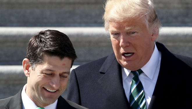 President Donald Trump confers with U.S. Speaker of the House Paul Ryan (R-WI) following a luncheon celebrating St. Patrick's Day at the U.S. Capitol on March 16, 2017 in Washington, DC. Ryan and Trump continue efforts to find support in both the House and Senate for the American Health Care Act.