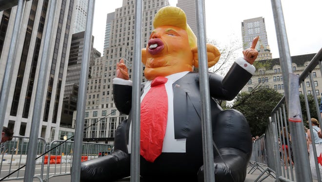 A giant inflated balloon in the likeness of President Trump's head on a rat body near Trump Tower  in New York on Aug. 14, 2017.