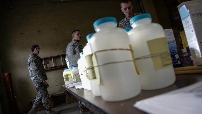 Water analysis test kits sit for Flint residents to pick up for lead testing in their drinking water on Monday, Jan. 18, 2016, at Flint Fire Department Station 1 in downtown Flint as members of the US Army National Guard 125th Infantry Battalion wait to help residents.