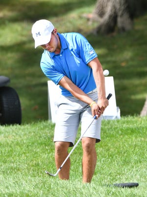 Nick Carlson of Hamilton, Michigan chips in a birdie from the rough off the 13th green of the North Course.